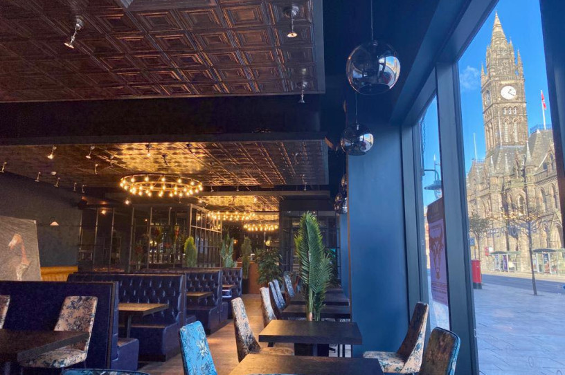 The interior of Rio Brazilian Steakhouse restaurant with a view of Middlesbrough Town Hall through the window