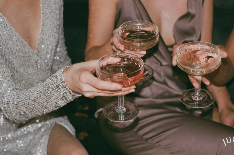 three cocktail glasses being held