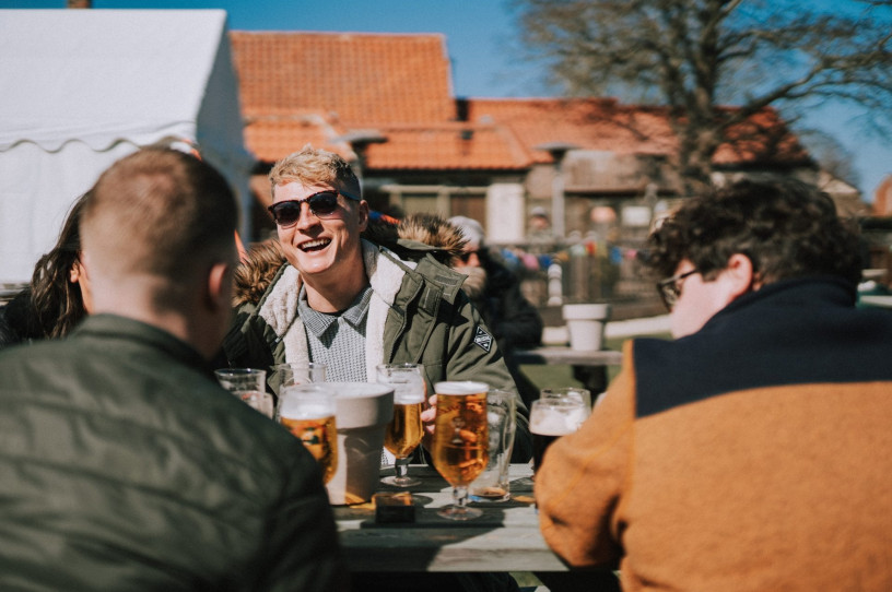 Friends laughing in the beer garden at The Raby Arms in Hart Village