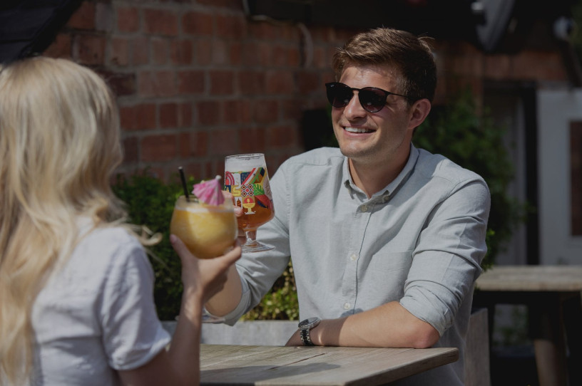 A couple enjoy drinks on Hash Bar & Kitchen roof terrace