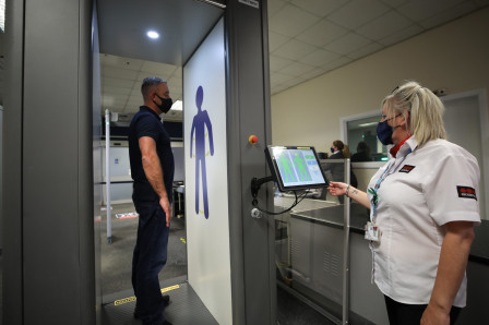 Passenger passes through security scanner at Teesside Airport