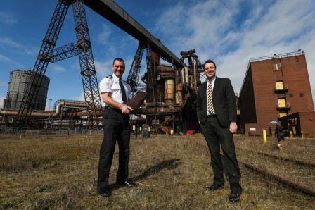 Chief Constable Richard Lewis holding the original iron from the Blast Furnace standing with Mayor Houchen